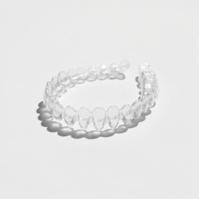 Clear Invisalign aligners on a white background